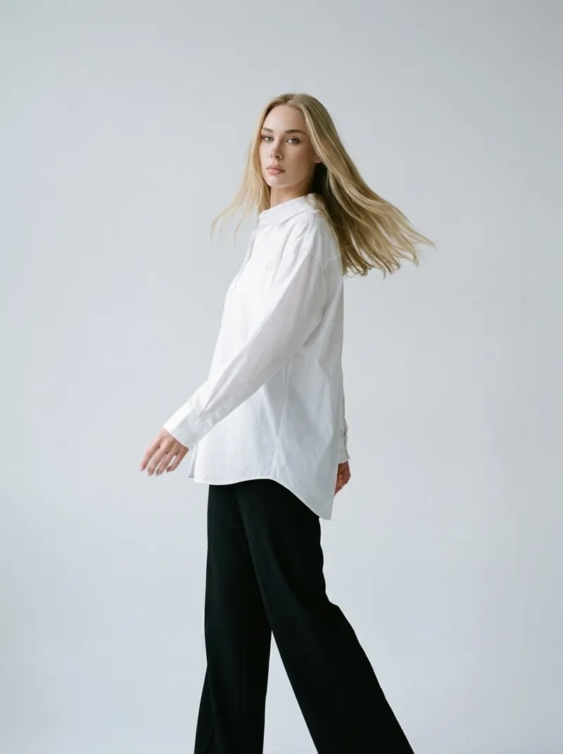 Studio fashion portrait of Anastasia Stepanenko in an oversized white shirt, hair in motion